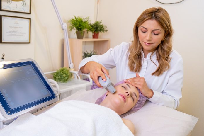 Woman in a spa salon on cosmetic procedures for facial care. Bea